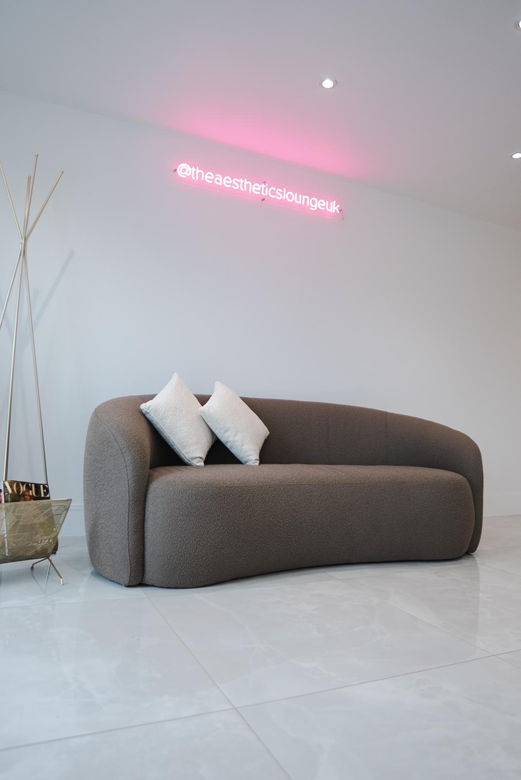 Couch in reception at The Aesthetics Lounge