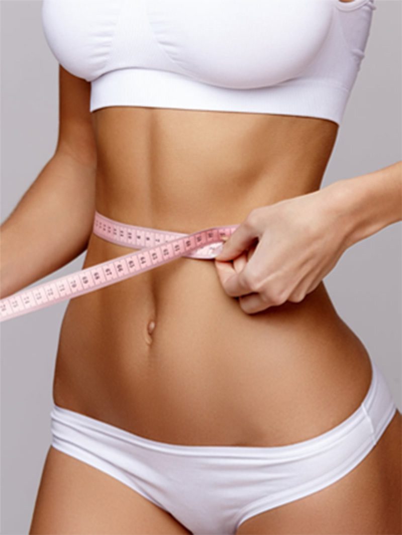 body-scultpting-featured Woman holding a tape measure around waist